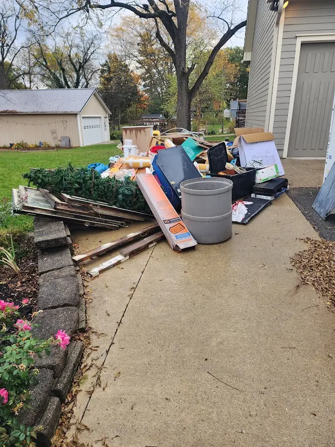 Dumpster being loaded with debris for 12 Yard Dumpster Rental in Bennington